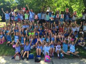 large group of summer camp kids outdoors for a group photo