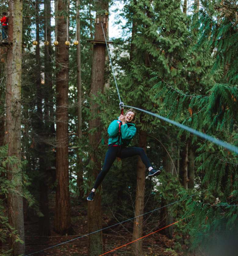 woman riding down a zipline