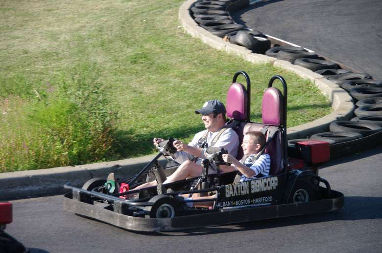 father and son on a go cart together