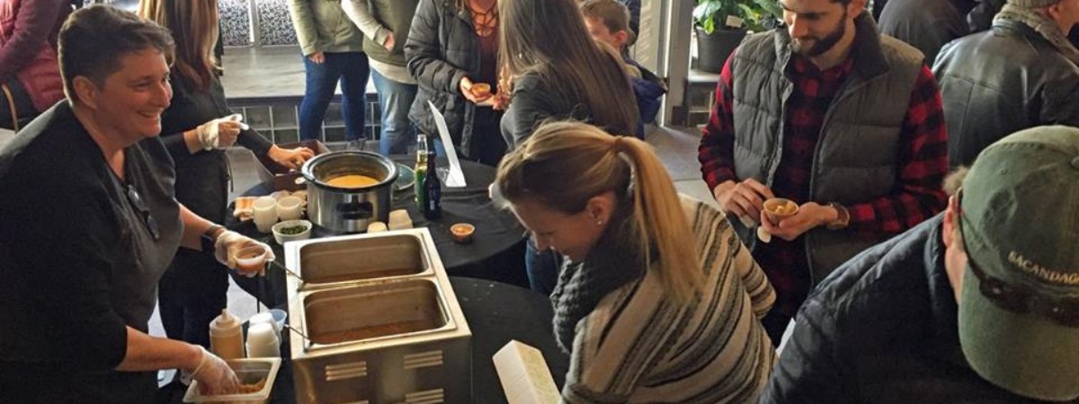 restaurant staff serving soup samples to customers