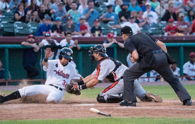 man sliding into home base