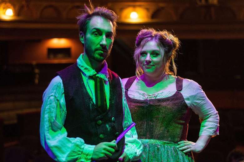 man and woman on stage in period pieces