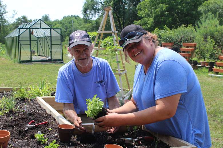 Two people planting in a garden