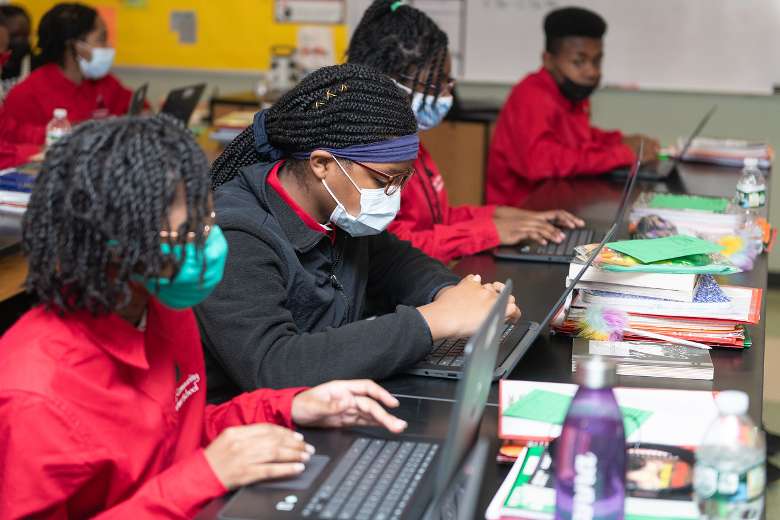 students at laptops in a classroom