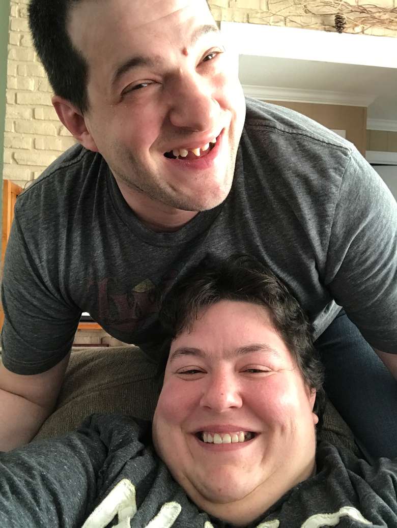A man and a woman smiling for the camera