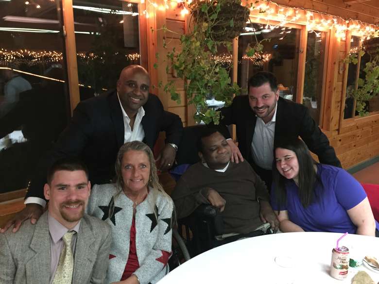 A group of six people smiling at a restaurant table