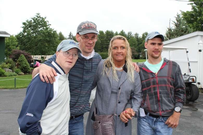 Four people smiling outside