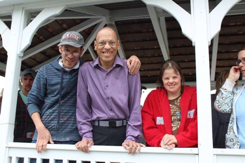 Three people in a gazebo smiling