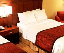 bed with red and white covers