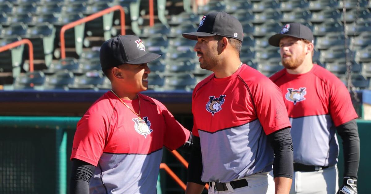 three players in red and gray jerseys