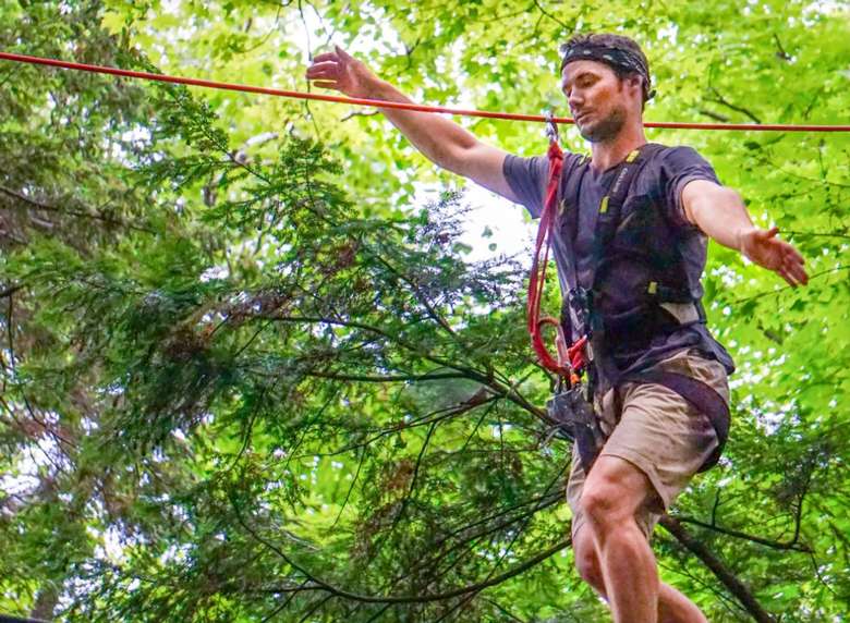 man on a treetop course